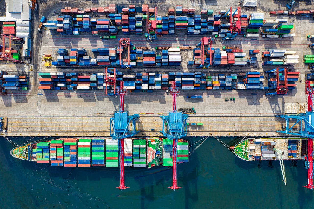 Drone shot capturing vibrant container ships and dock in North Jakarta port, Indonesia.